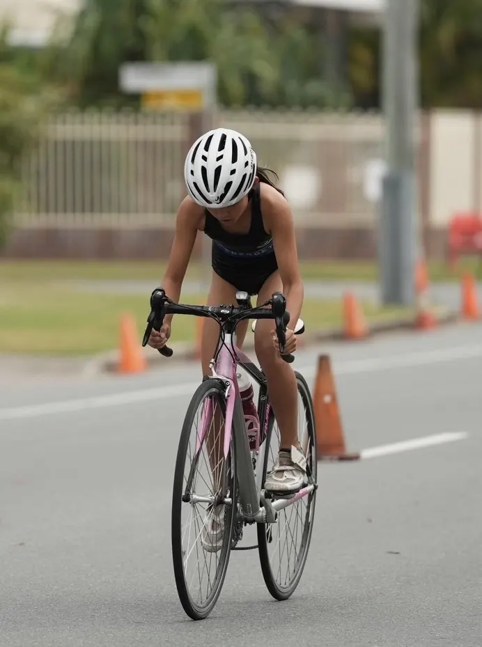 Chloe competing in the cycling leg of a triathlon